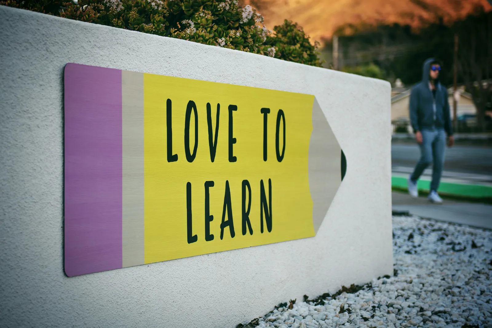 A wall mural shaped like a pencil reading Love To Learn
